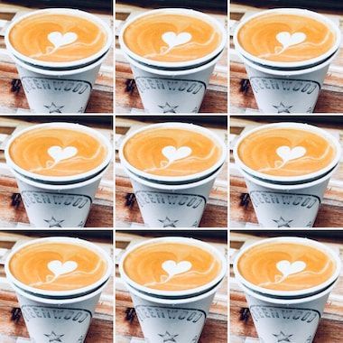 Nine cups of latte art with white heart designs arranged in a 3x3 grid