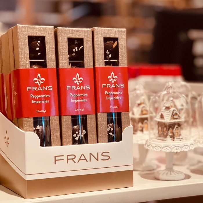 FRANS chocolate gift box with red labels on a store display beside a clear crystal ornament
