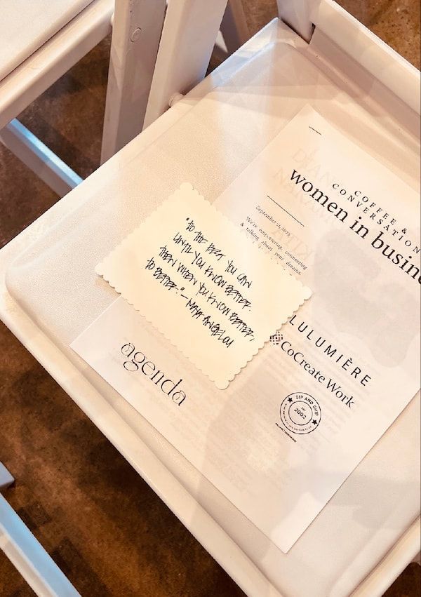 Framed menu or sign on a table, showing printed text and a small note card.