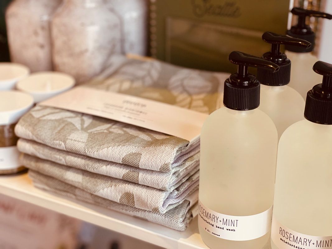 Stacked folded towels and pump bottles on a spa countertop