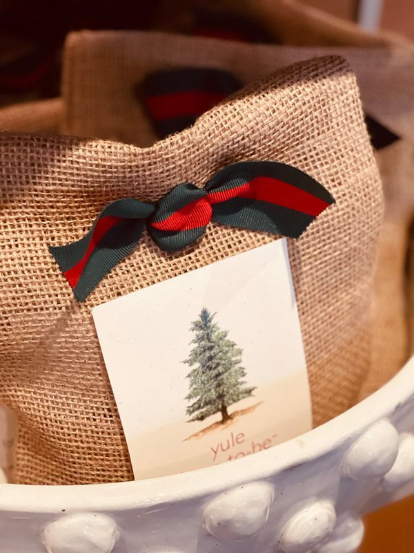 Gift bag with burlap texture, black-and-red ribbon, and a holiday card featuring a Christmas tree.