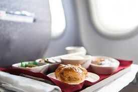 Airplane tray with a meal on a red napkin by the window