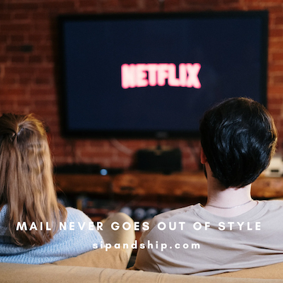 Couple watching Netflix on a TV in a brick-walled living room with “Mail never goes out of style” text.