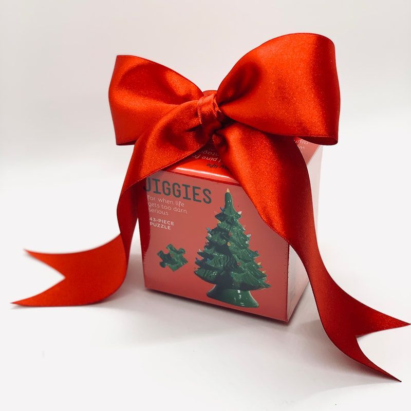 Red gift box with a large red bow and ribbon, labeled “BIGGIES” with a Christmas tree design