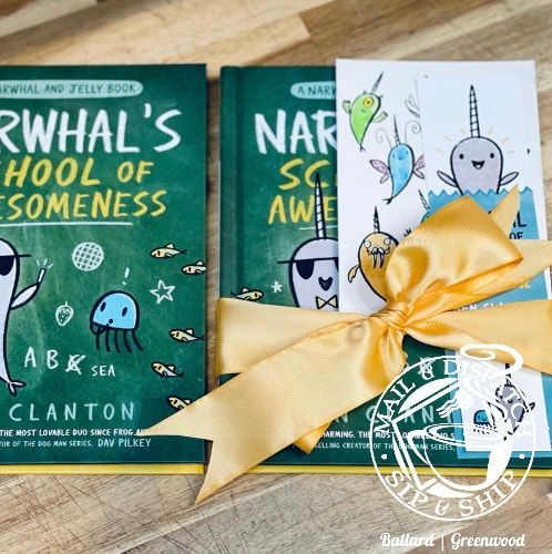 Two green children’s books and a wrapped gift with a cartoon card and yellow bow