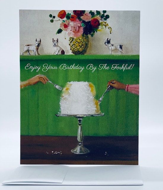 Birthday card with green background, white cake on a stand, and floral bouquet above the greeting text.