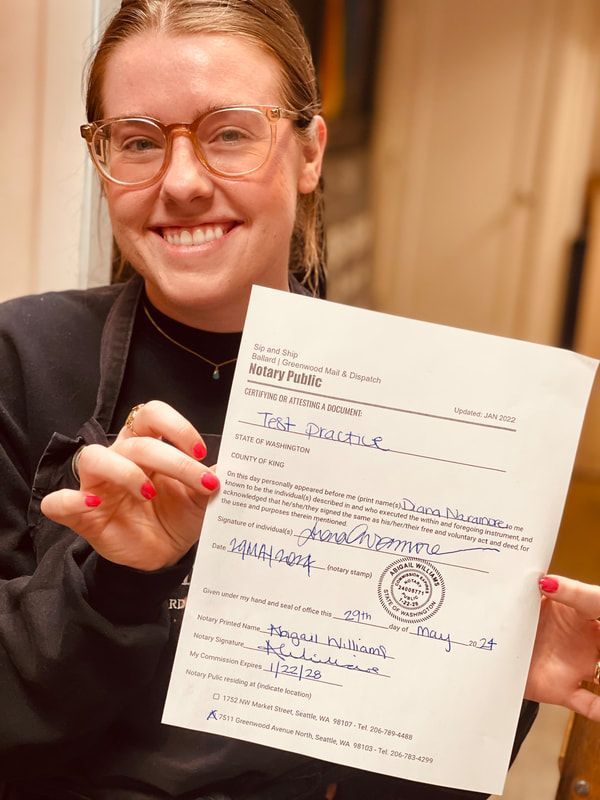 Smiling person holding up a signed document toward the camera