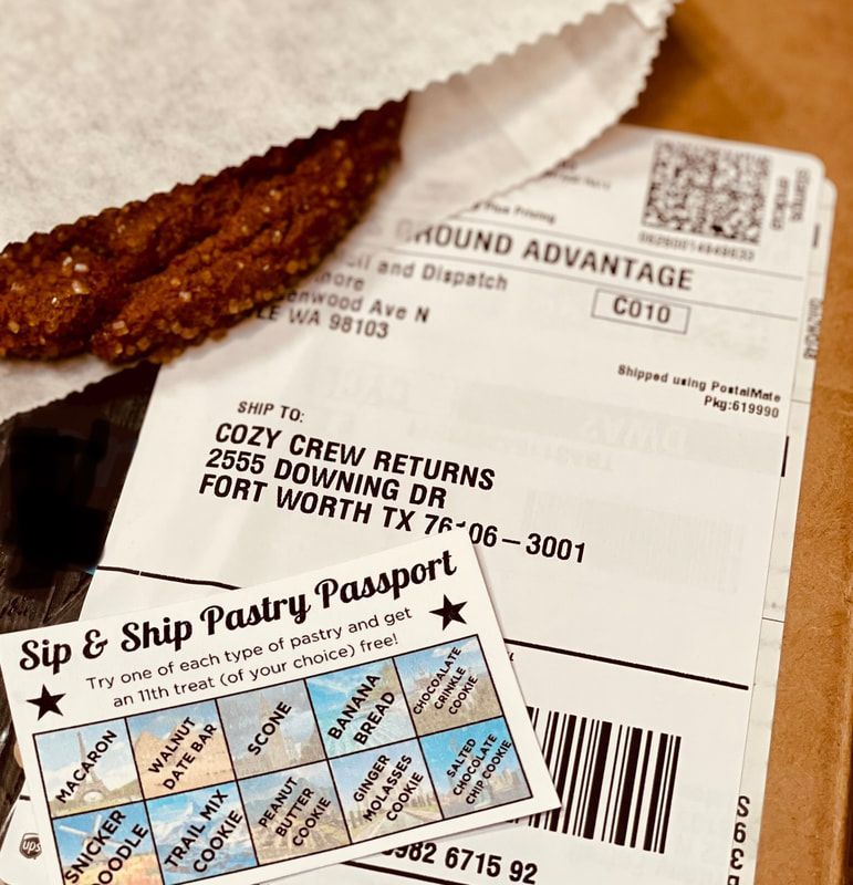 Coffee loyalty cards and a receipt beside a chocolate pastry on a wooden table