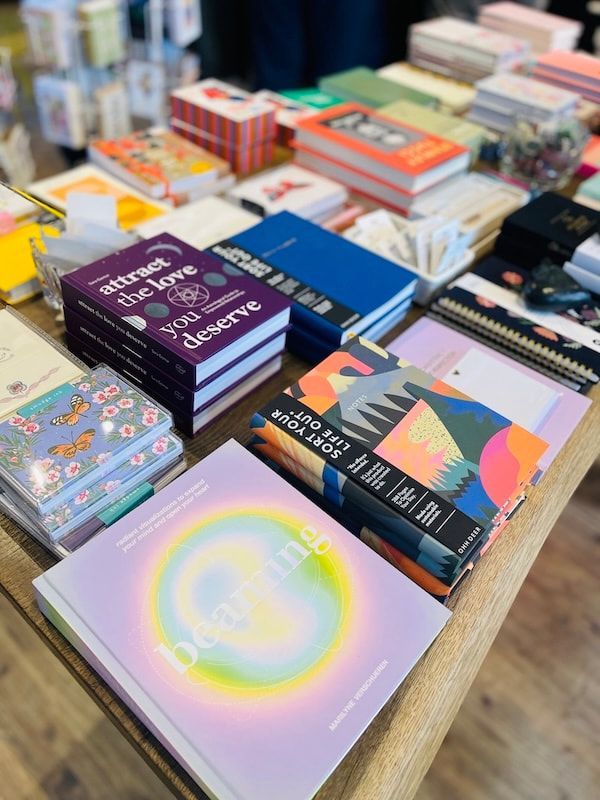 Assorted colorful stationery and notebooks arranged on a table in a shop display