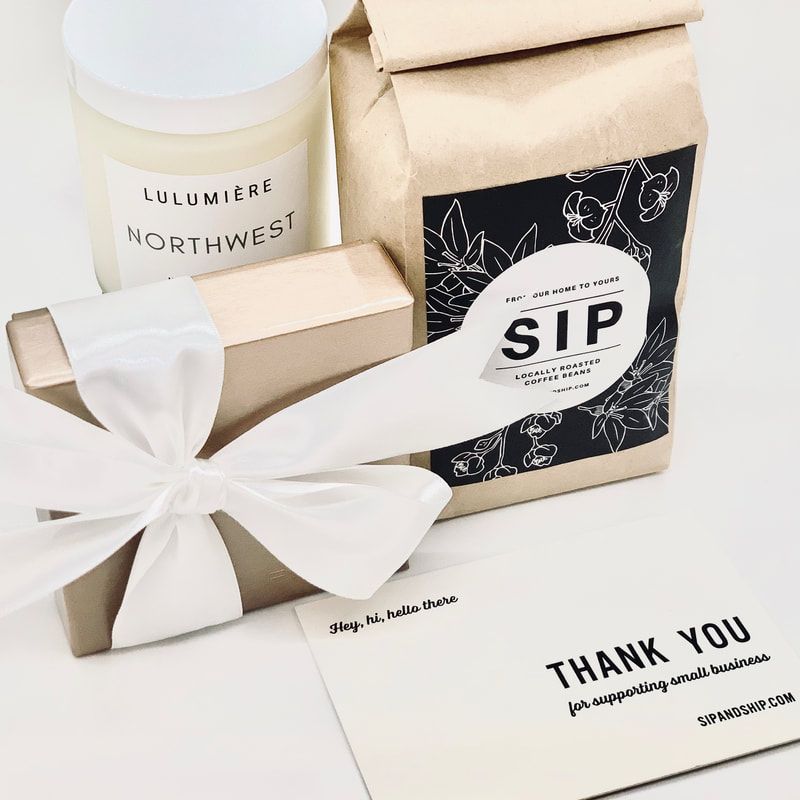 Gift box, candle, and cup with white ribbon and thank-you card on a white background.