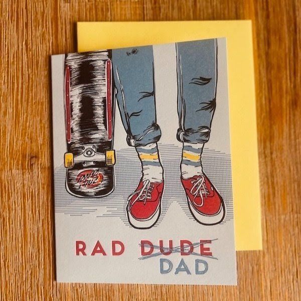 “Rad Dude Dad” card with illustrated jeans, red sneakers, and a skateboard on a yellow note card