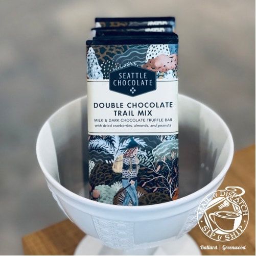 Seattle Chocolate Double Chocolate Trail Mix bar in a white bowl on a wooden table