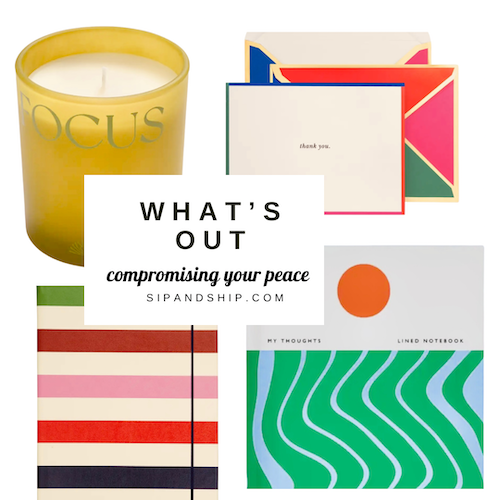 Assorted colorful stationery and candles with a card reading “What’s Out” on a white background