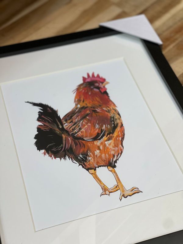 Watercolor rooster in orange, red, and black on white paper, displayed in a black frame.