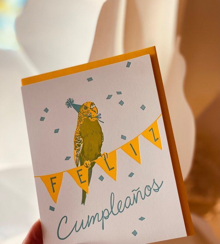 Handmade birthday card with a bird, confetti, and “Feliz Cumpleaños” text