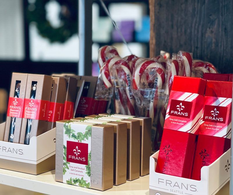 Gift boxes and candy displays in red, white, and brown on a shop counter with FRANS branding