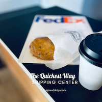 FedEx shipping box with a muffin and a white coffee cup on top