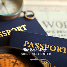 Dark blue passports with gold lettering and a key ring on a desk beside a map.