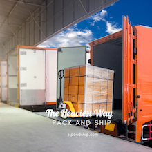 Open shipping containers with boxed cargo inside warehouse dock under blue sky