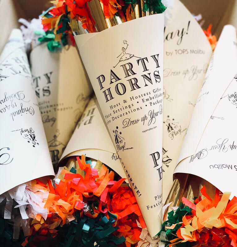 Paper party horns with colorful confetti ends in festive cream and orange packaging.