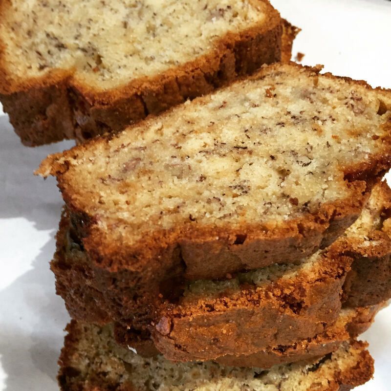 Stack of sliced banana bread on a white surface