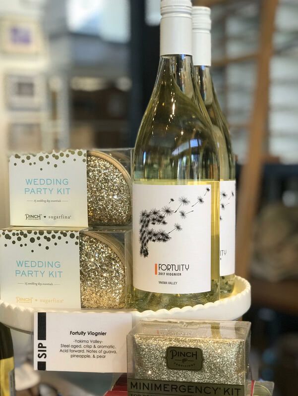 Wedding party kit gift set with champagne bottles and boxed favors on a tray