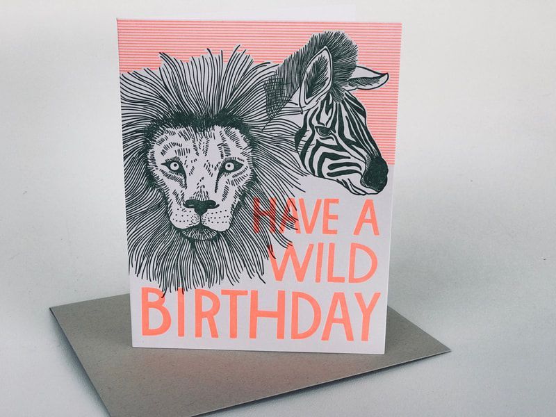 Greeting card with a lion and zebra illustration and the text “Have a wild birthday”