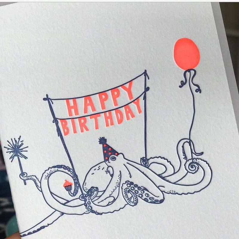 Octopus holding a “Happy Birthday” banner with a red balloon and party hat