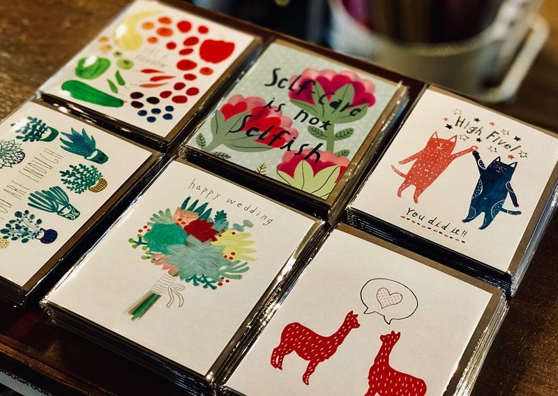 Decorative hand-painted ceramic tiles with colorful floral and animal designs displayed in a tray