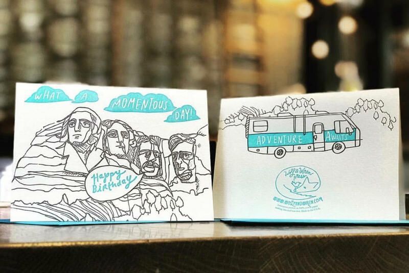 Open sketchbook with black-and-blue drawings of the Sphinx and a tram
