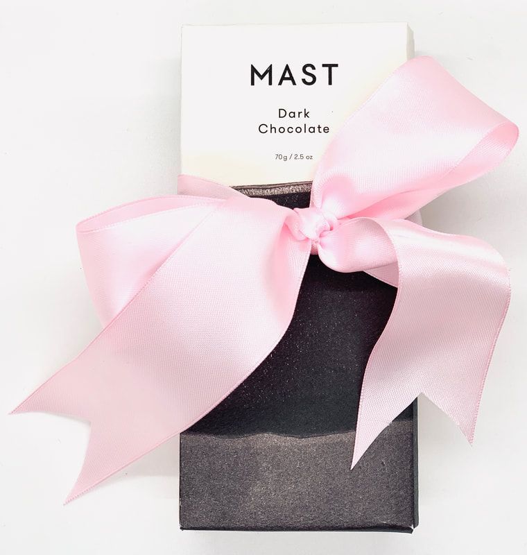 Dark chocolate gift box with a large pink ribbon bow