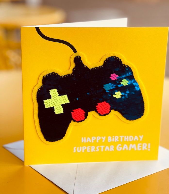 Yellow birthday card with a black game controller and “Happy Birthday Superstar Gamer!” text
