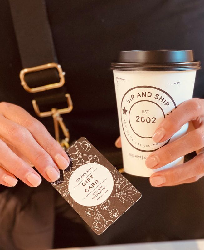 Hands holding a coffee cup and a “gift of care” card against a dark background.