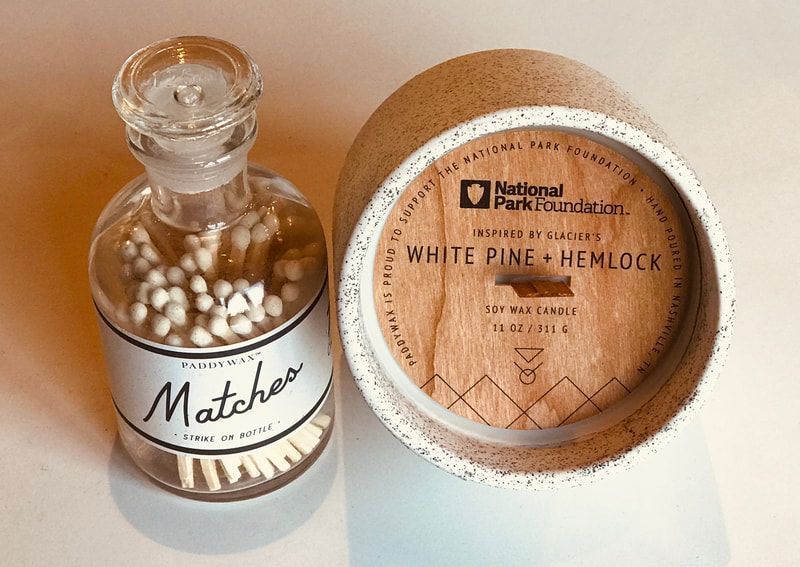 Glass bottle and round tin labeled White Pine-Hemlock with white beads on a beige surface