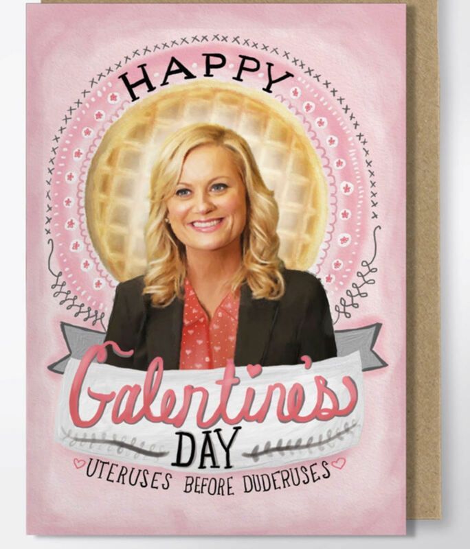 Pink “Happy Valentine’s Day” card with a smiling blonde woman and the phrase “Uteruses Before Duderuses.”