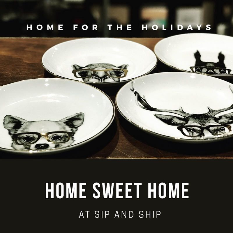 Four white pet dishes with black dog illustrations and holiday text on a wooden surface