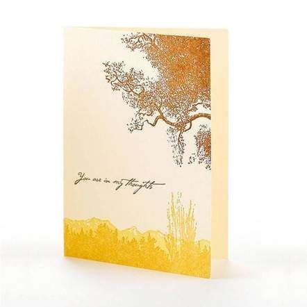 Elegant cream greeting card with a gold tree and yellow floral design at the bottom