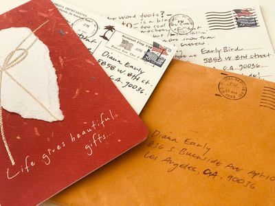 Three handwritten airmail envelopes and cards in red, white, and orange