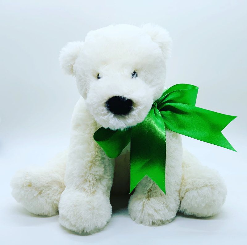 White teddy bear with a bright green ribbon bow against a white background