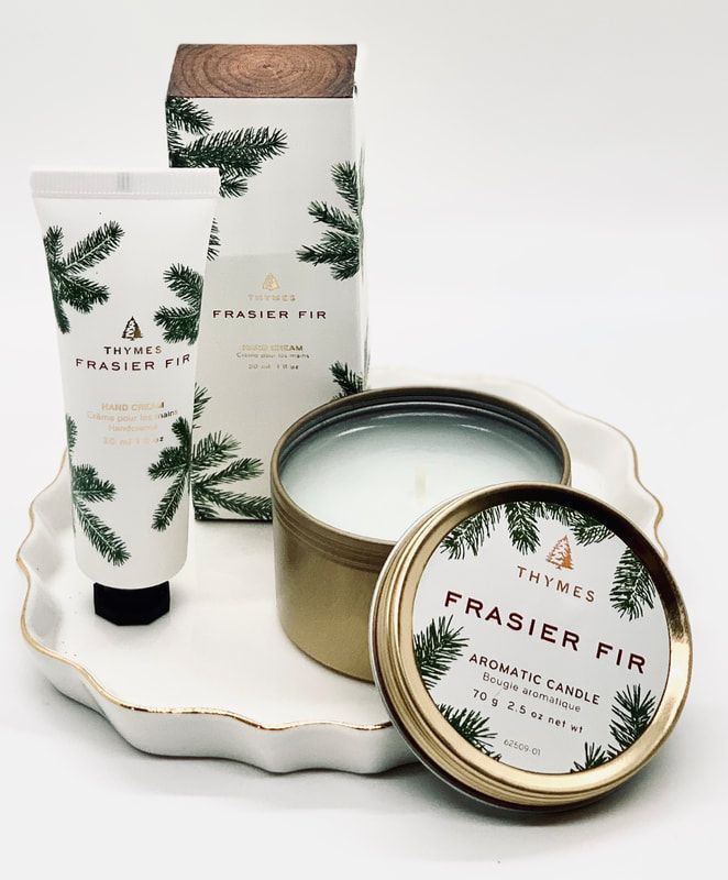 Frasier Fir candle, tube, and candle tin on a white tray with evergreen accents