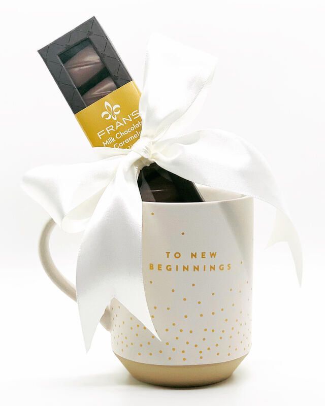 Gift mug with a white ribbon and chocolate bar, reading 