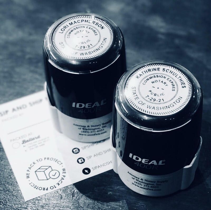 Two black skincare jars on a card, labeled IDEAL, viewed from above on a dark surface.