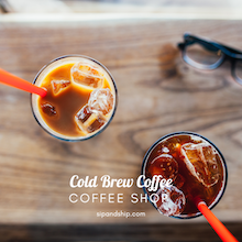 Two iced cold brew coffees with orange straws on a wooden table, one with sunglasses nearby