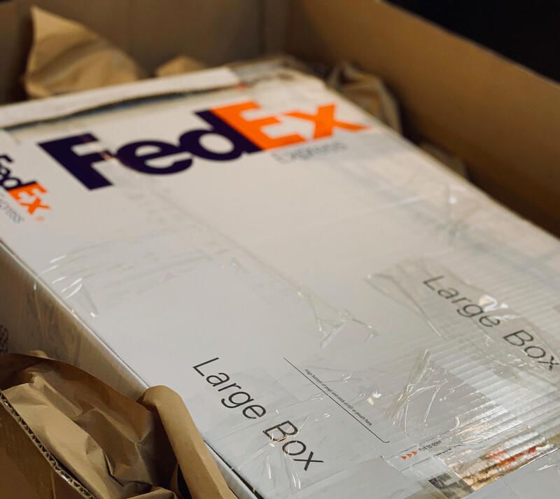 FedEx large box packed inside a cardboard shipping carton