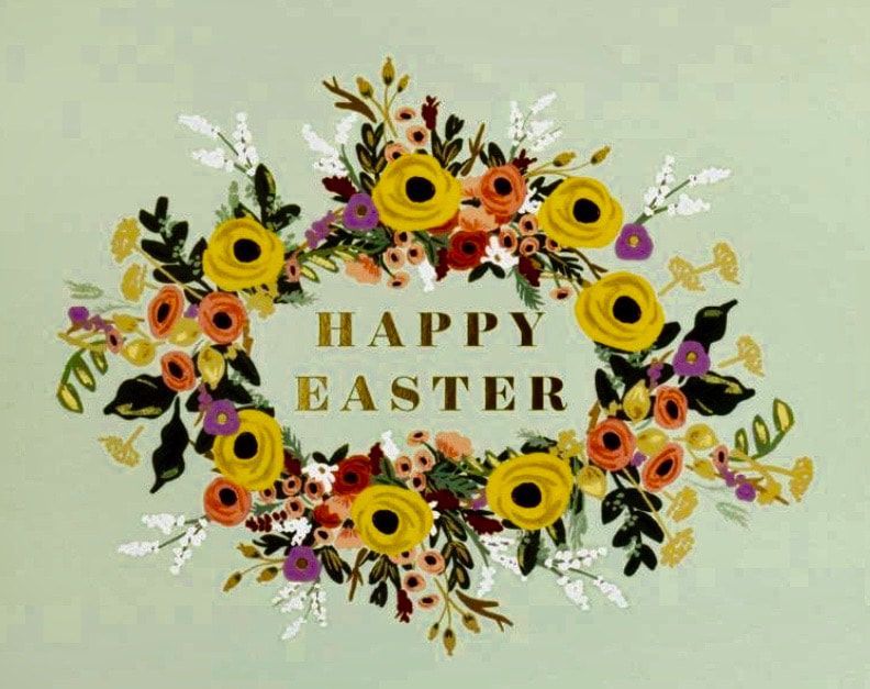 Floral wreath with sunflowers, roses, and greenery surrounding the words “HAPPY EASTER” on a pale green background