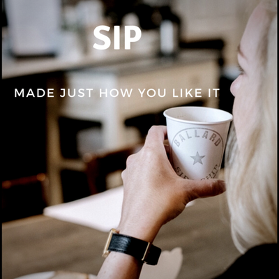 Person holding a white coffee cup in a café with text reading “SIP” and “MADE JUST HOW YOU LIKE IT”