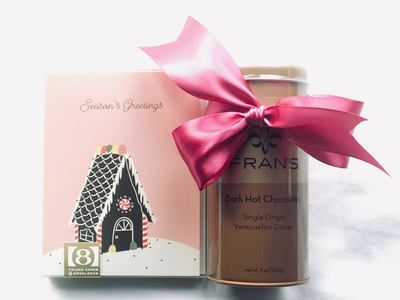 Pink gift box and coffee can tied with a magenta ribbon, styled for a birthday gift.