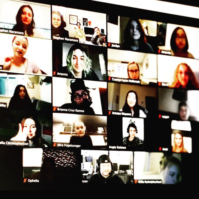 Video conference gallery view with many participants on a dark background, some smiling and some on camera at home.