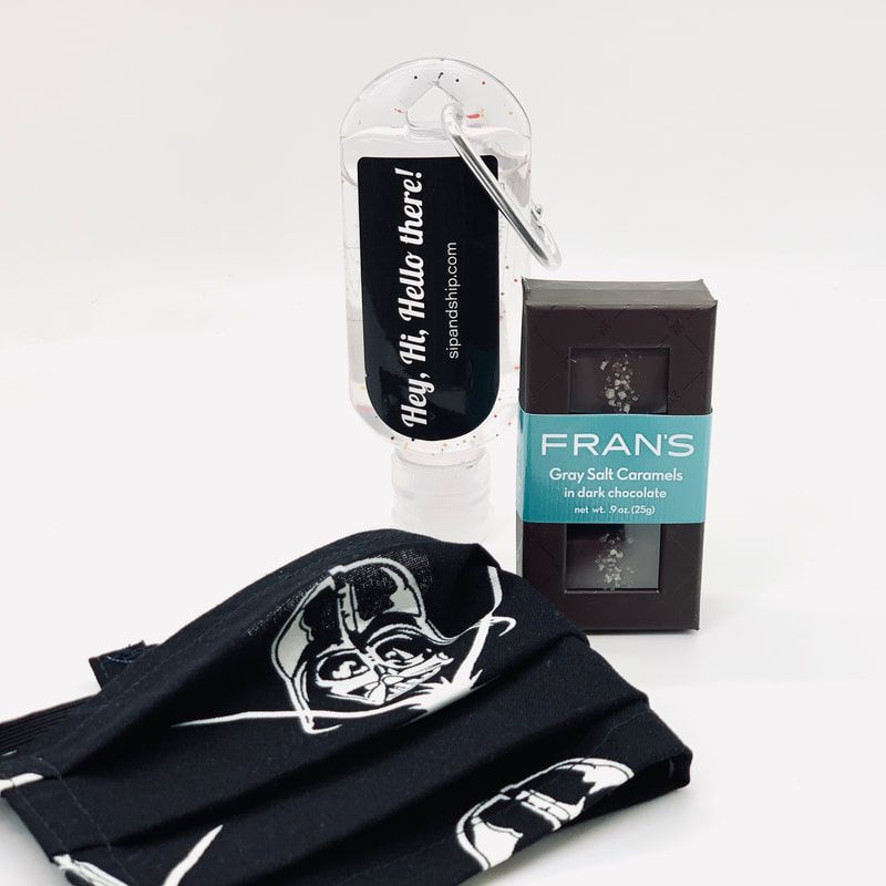 Black Star Wars-themed socks, a bottle with a tag, and a FRANS gray salt scrub package on a white background