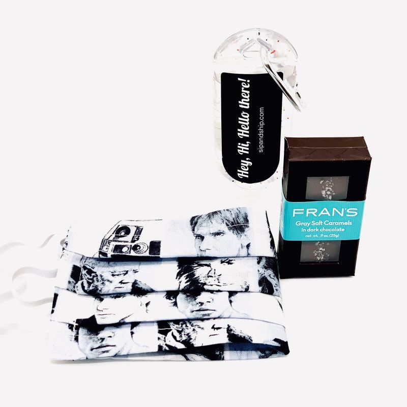 Assorted black-and-white printed apparel and accessories with a boxed product on a white background